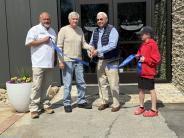 Ben Winkelman, Jim Dixon and Frank Early, assisted by student Banks Barton, cut the ribbon for the Rome-Floyd ECO Center