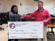 Monique McBride, GEMA presents check to Troy Atkins, Assistant Administrator